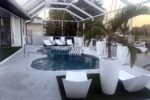 Pool loungers and canal view at sunset — Canal Villa