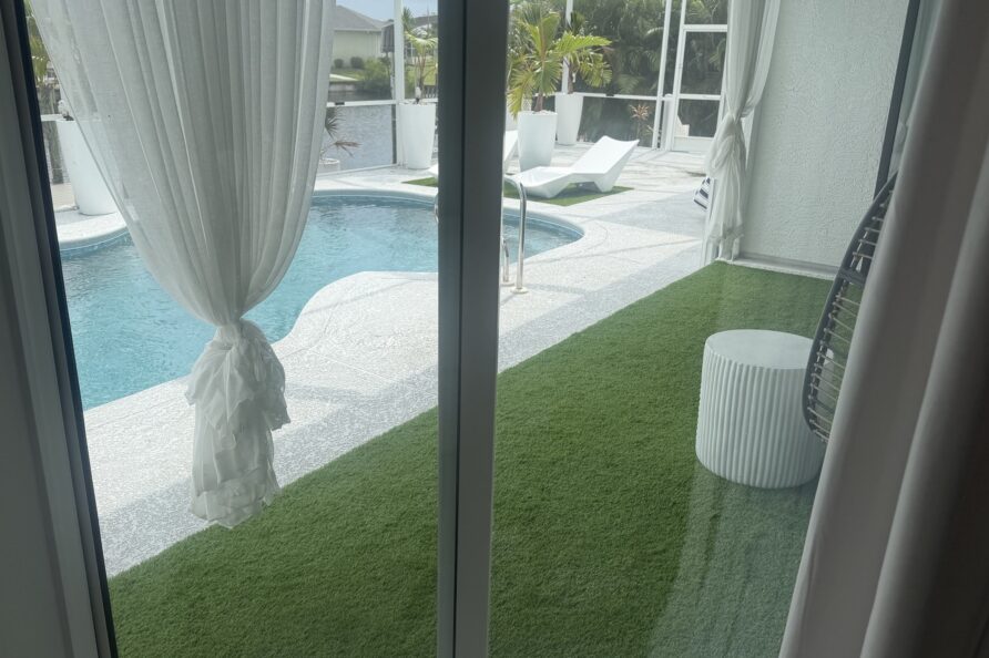 Heated screened pool with sun loungers and private dock
