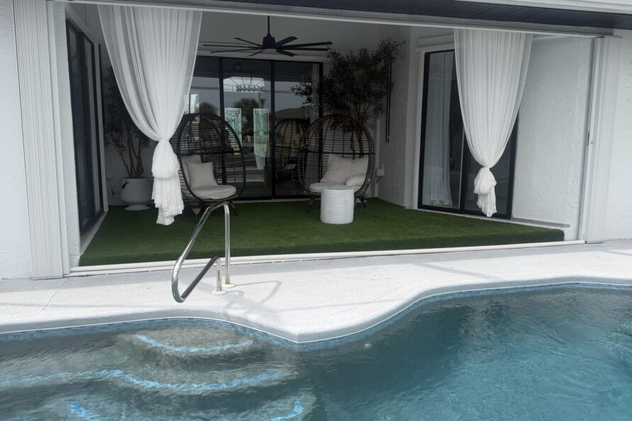 Turf backyard leading to the pool