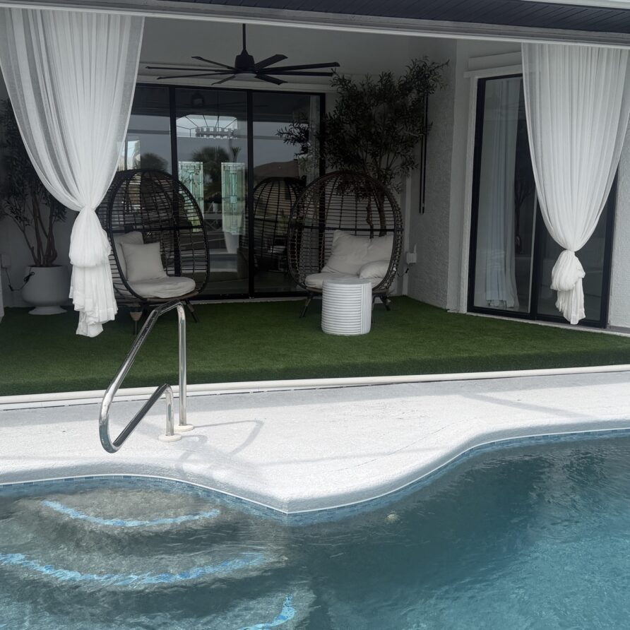 Turf backyard leading to the pool