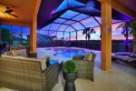 Luxury 4BR Villa Punta Gorda Isles heated saltwater pool and lanai at sunset